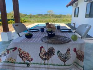 a table with a table cloth with chickens on it at Farmer's house in El Quije