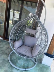 a hanging chair with pillows on a balcony at Farmer's house in El Quije