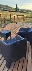 two couches and a table on a wooden deck at Cabaña A&A in Sierra de la Ventana +1 photo