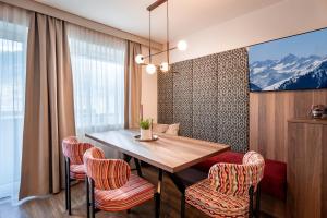 a dining room with a table and chairs at Apart Denise in Fügen