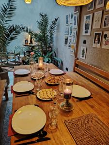 a wooden table with plates and glasses and food on it at L'îlot in Sidi Ifni