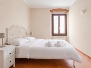 a bedroom with a white bed with towels on it at Paradise Apartment, Comfort e Private Parking in Prato