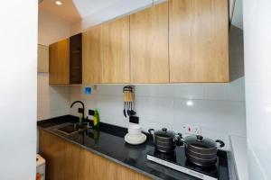 a kitchen with two pots on a stove top oven at Studio Room by Elegushi beach resort in Mama