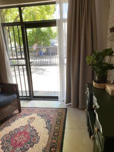 a living room with a door open to a patio at The cozy acre in Potchefstroom