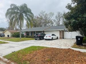 a house with two cars parked in a driveway at My Dream Space in Orange Park