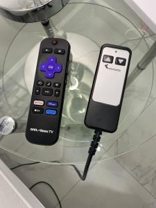 a remote control sitting on top of a glass table at My Dream Space in Orange Park +34 photos