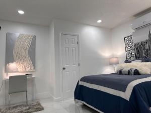 a bedroom with a bed and a table and a mirror at My Dream Space in Orange Park