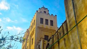 a building with a cross on the top of it at St Thomas Guesthouse - Jerusalem in Jerusalem +65 photos