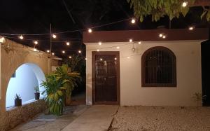 a house with a door with lights on it at Casa Polito in Izamal