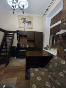 a living room with a kitchen with a table at Old Wine House, self check - in in Klaipėda
