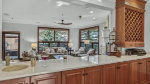 a kitchen with a sink and a living room at Chalet Premio in Beaver Creek