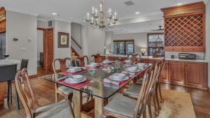 a dining room with a glass table and chairs at Chalet Premio in Beaver Creek