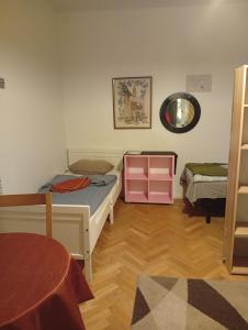 a bedroom with two beds and a mirror on the wall at B&BAnjana in Vaggeryd