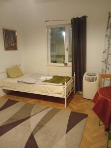 a small bedroom with a bed and a window at B&BAnjana in Vaggeryd