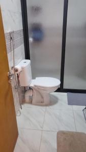 a bathroom with a toilet and a shower stall at Mini villa trougout in Al Hoceïma