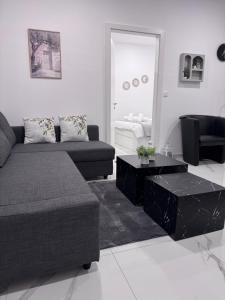 a living room with a couch and a coffee table at Casa Elia AXD in Alexandroupoli