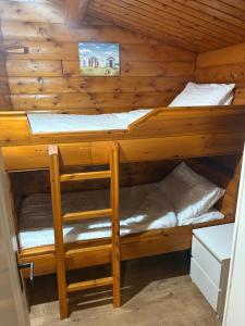 two bunk beds in a log cabin at Home From Home LogCabin in Trawsfynydd