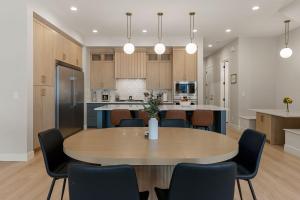 a kitchen and dining room with a table and chairs at Weekend Vibes townhouse in St. George