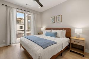 a bedroom with a large bed and a window at Weekend Vibes townhouse in St. George