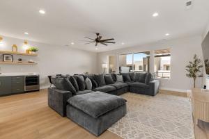a living room with a couch and a ceiling fan at Weekend Vibes townhouse in St. George