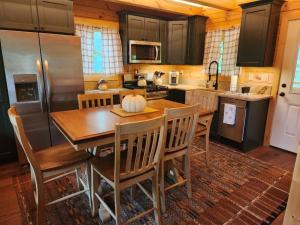 a kitchen with a table with chairs and a refrigerator at Chincoteague in Chincoteague