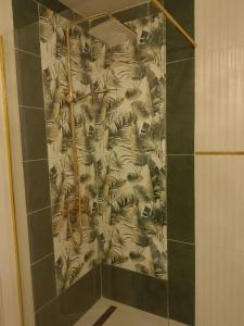 a bathroom with a shower with a curtain with animals at Apartament Green Tara in Oradea