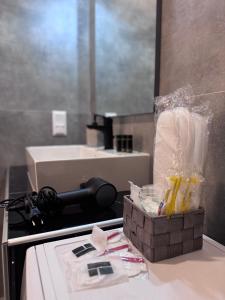 a bathroom with a counter with a box of toothpaste at Casa Elia AXD in Alexandroupoli