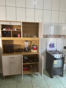 a small kitchen with a counter and a stove at Apto garagem incluso in Marabá