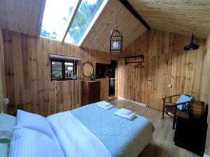 a bedroom with a bed in a room with wooden walls at Buen Paso in Icod de los Vinos
