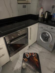 a kitchen with a stove and a washing machine at Veranda resort in Hurghada