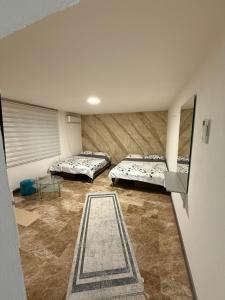 a room with two beds and a table in it at Stan na dan Berane in Berane