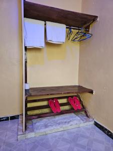 a pair of red shoes sitting on a bench in a room at ZuriStay in Nakuru