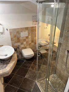 a bathroom with a shower and a toilet and a sink at Rent Room Sardegna in Porto Torres +8 photos