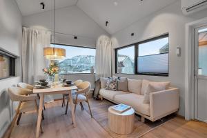 a living room with a couch and a table at Unique Tromsø mini-house! in Tromsø