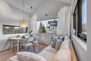 a living room with a couch and a table at Unique Tromsø mini-house! in Tromsø +18 photos