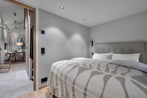 a bedroom with a large bed and a dining room at Unique Tromsø mini-house! in Tromsø