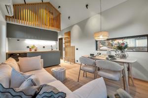 a living room and kitchen with a couch and a table at Unique Tromsø mini-house! in Tromsø