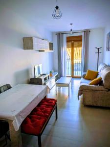 a living room with a table and a couch at Gracia apartment in Baeza