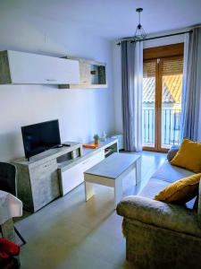 a living room with a couch and a tv at Gracia apartment in Baeza +31 photos