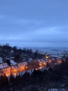 a group of buildings with snow on them at night at Apartament Zimowa 16 in Srebrna Góra