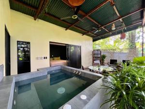 an indoor pool in a house with a bedroom at Jungle House with Private Jacuzzi in Uvita