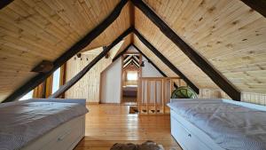 a large room with a bed in a attic at Holiday Home BIBA With Heated Outdoor Pool in Gornja Stubica