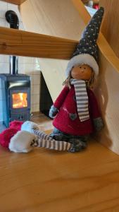 a doll wearing a santa hat sitting on a shelf at Holiday Home BIBA With Heated Outdoor Pool in Gornja Stubica +31 photos
