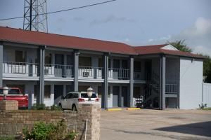 een witte auto geparkeerd voor een gebouw bij Royal Inn in Port Arthur