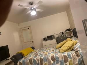 a bedroom with a bed and a ceiling fan at Motel in Wednesbury