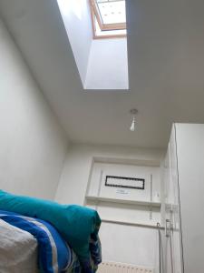 a attic room with a bed and a skylight at Motel in Wednesbury