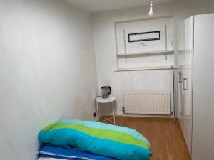a small room with a bed and a table at Motel in Wednesbury