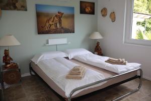 a bedroom with a bed with a picture of a dog at Casa Bellavista Rovio in Rovio +48 photos