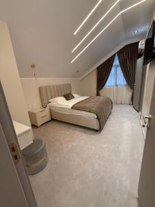 a bedroom with a bed and a window at Sadova Loft View in Sadova
