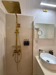 a bathroom with a sink and a shower at Sadova Loft View in Sadova +41 photos